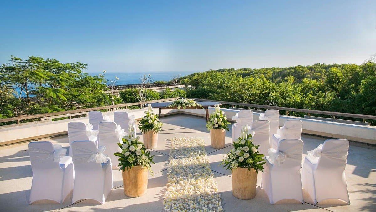 Alila Uluwatu — chairs set for a ceremony on the clifftop terrace · Uluwatu, Indonesia