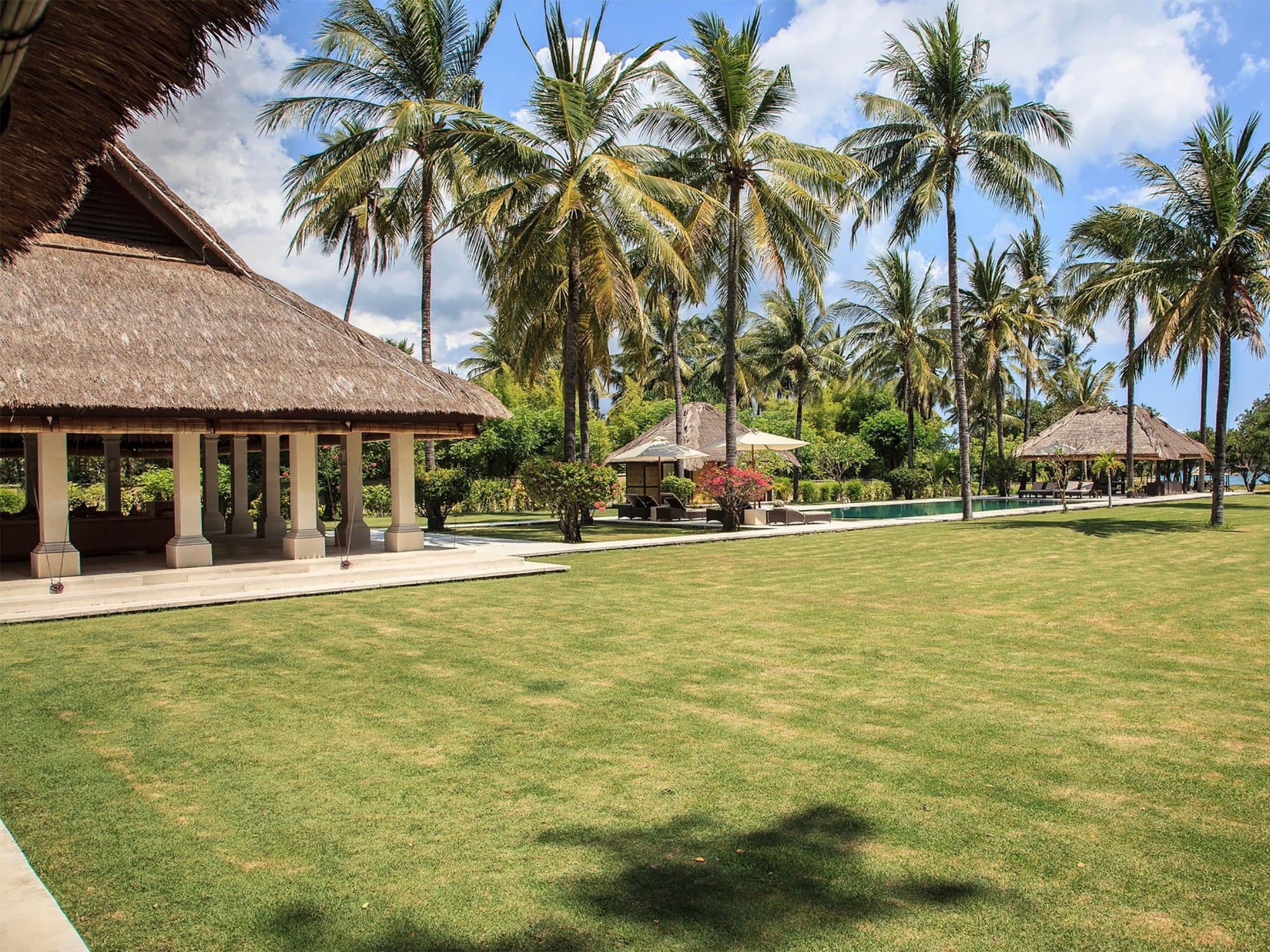 Sepoi Sepoi — the lawn and pavilions among coconut palms · Lombok, Indonesia
