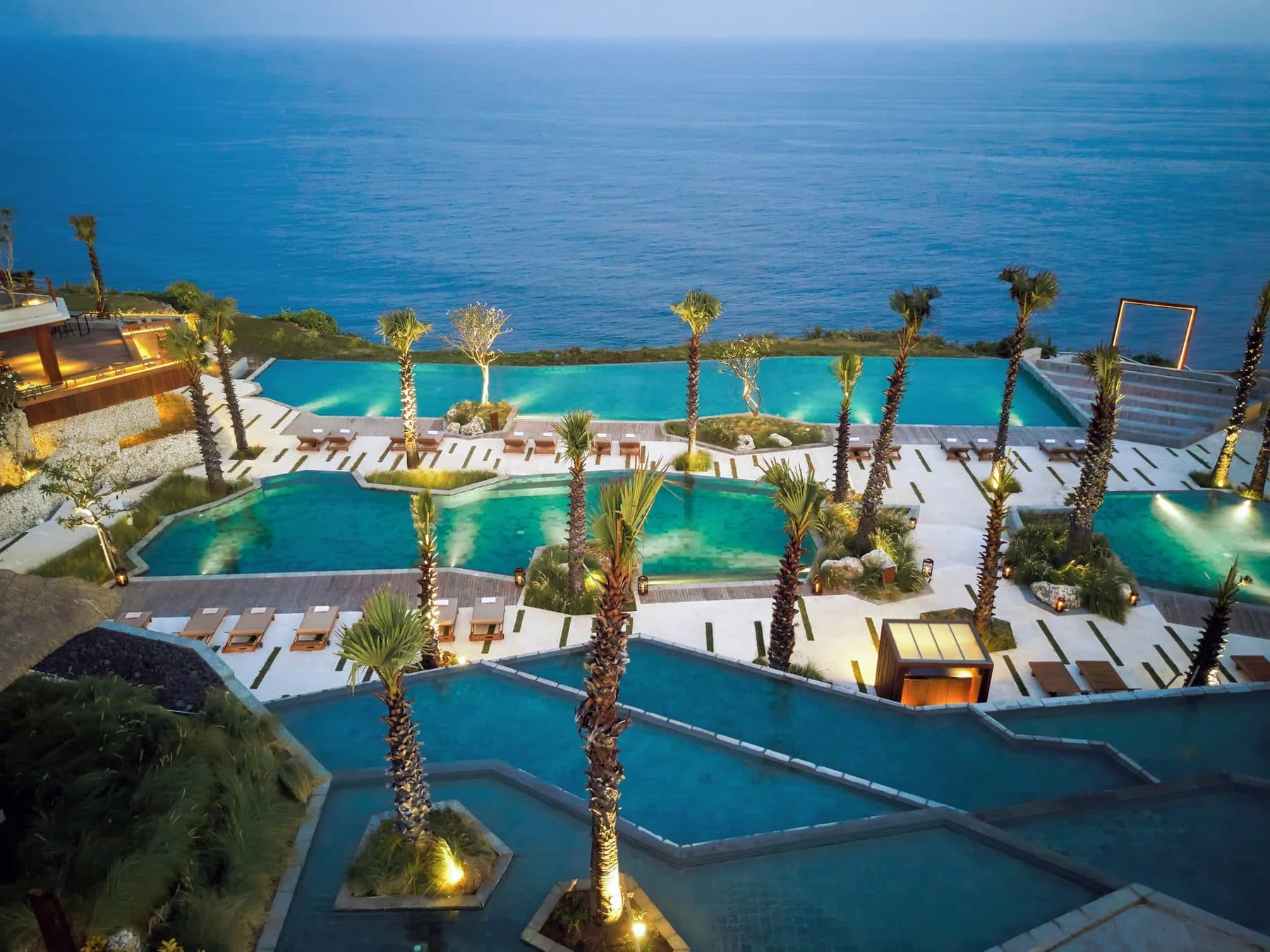 Six Senses Uluwatu — the terraced pools and palms at dusk · Uluwatu, Indonesia