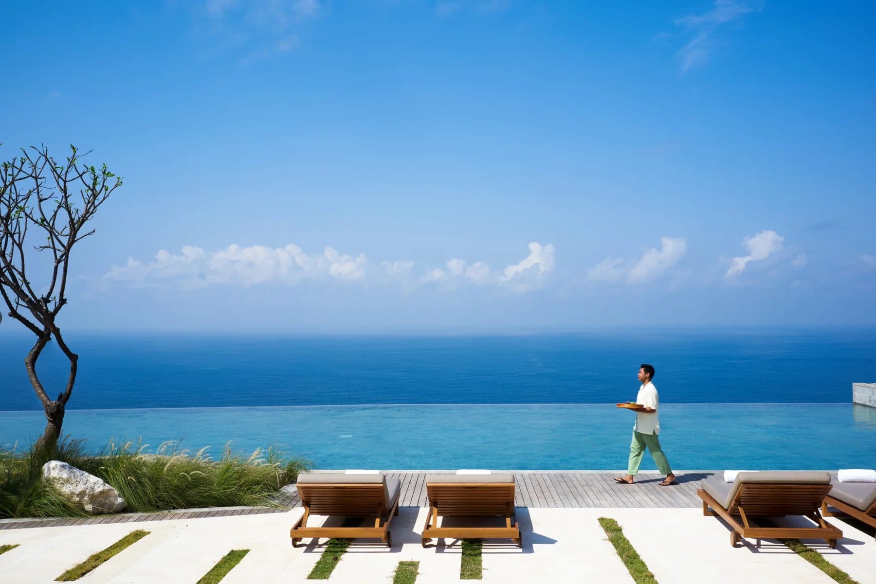 Six Senses Uluwatu — the infinity pool and loungers above the ocean · Uluwatu, Indonesia