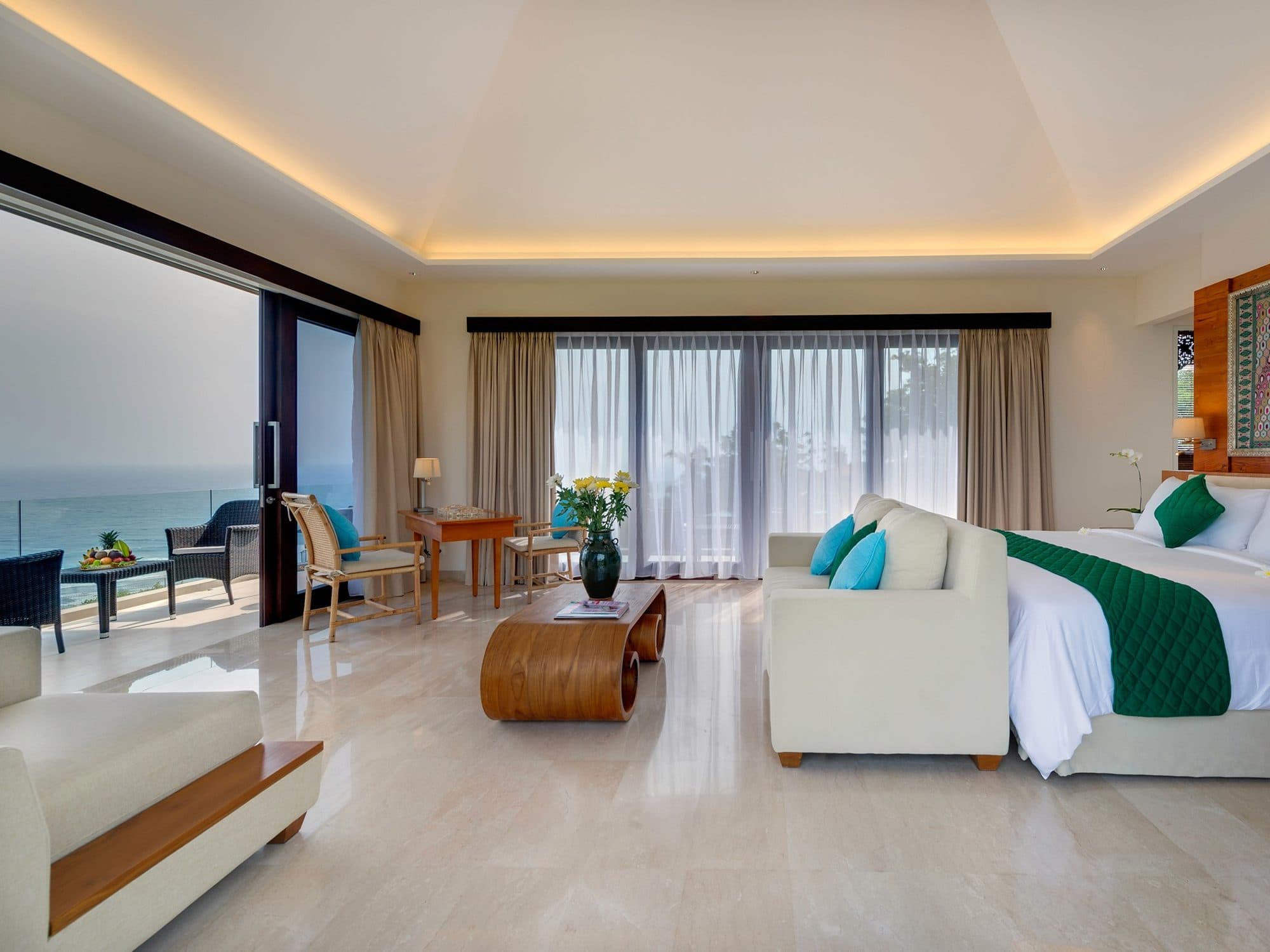 The Pala — a bedroom opening onto a sea-view balcony · Bali, Indonesia