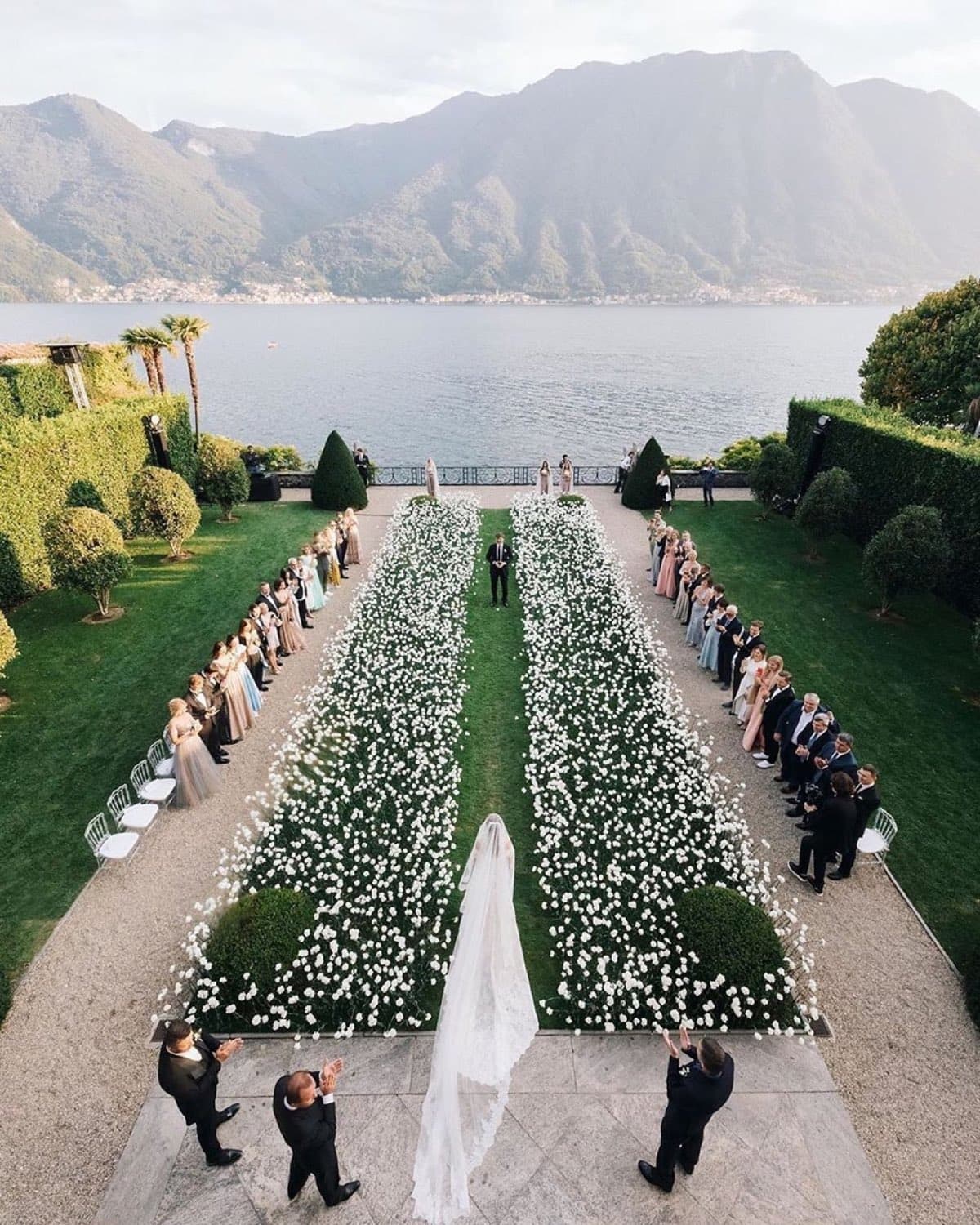Villa Balbiano — aerial view of a ceremony in the Italian garden, the aisle lined with white flowers · Lake Como, Italy