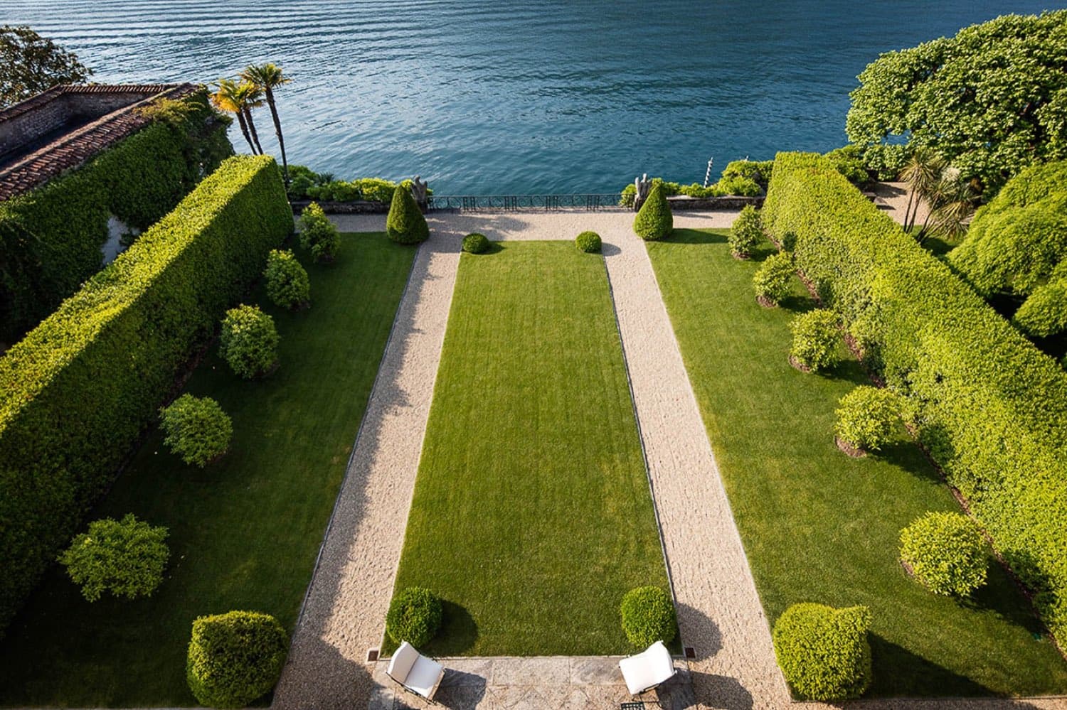 Villa Balbiano — the formal garden of lawns and clipped hedges running down to the lake · Lake Como, Italy