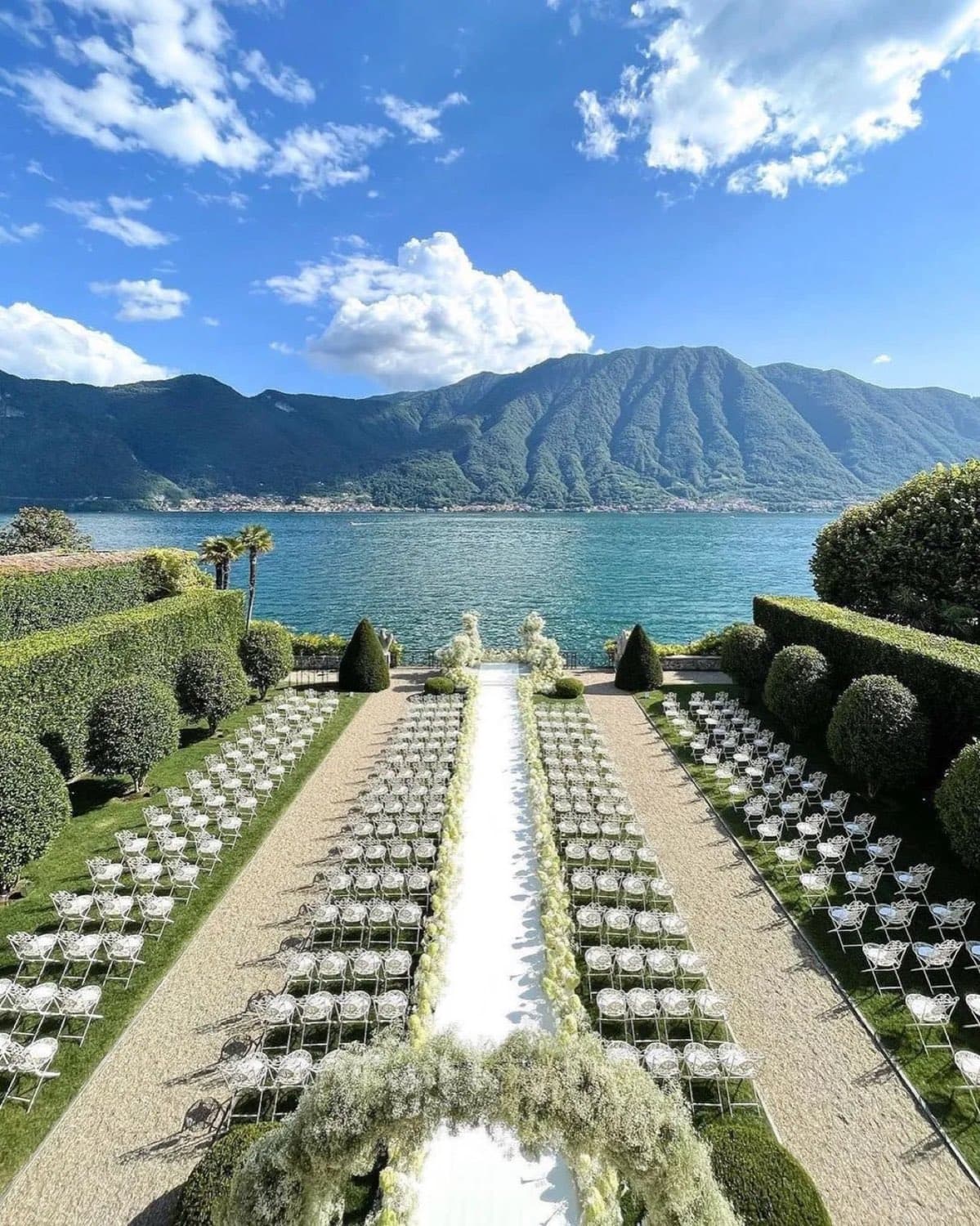 Villa Balbiano — a ceremony set in the Italian garden, rows of chairs facing the lake · Lake Como, Italy