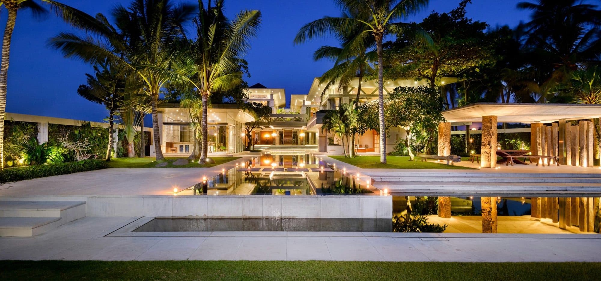 Villa Vedas — the villa and its reflecting pool lit at night · Bali, Indonesia
