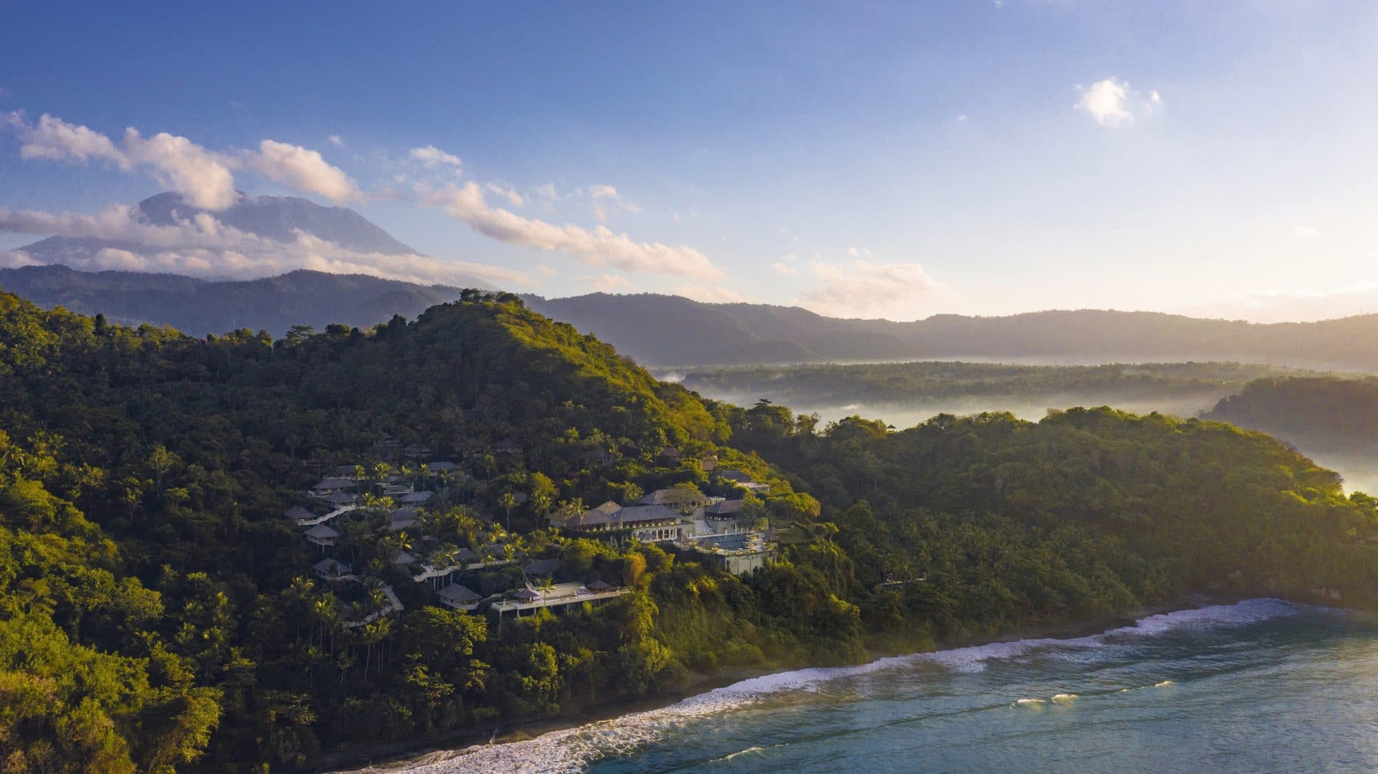Amankila — the hillside resort above the sea, mountains beyond · Manggis, Indonesia