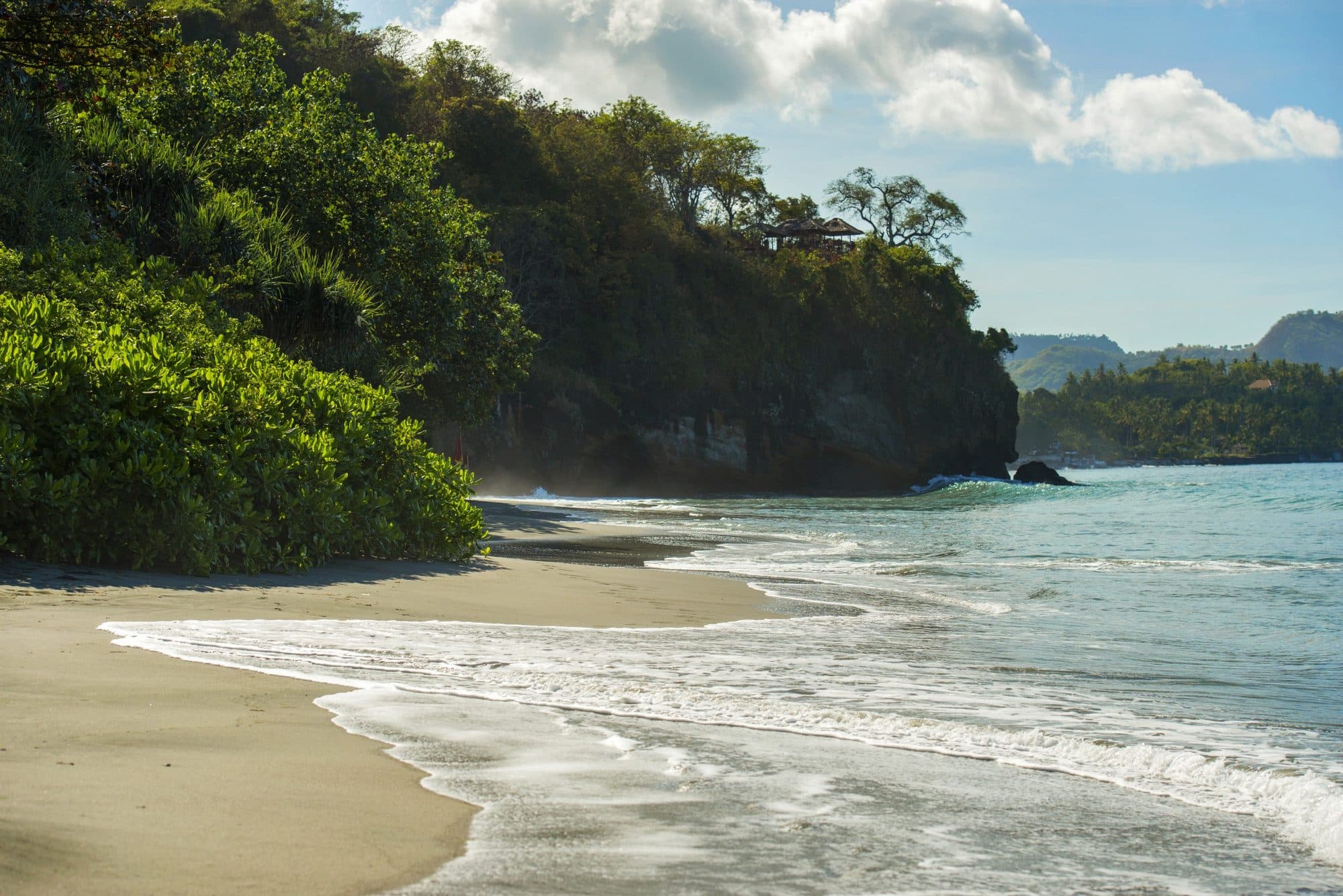Amankila — the beach and cove below the jungle cliffs · Manggis, Indonesia