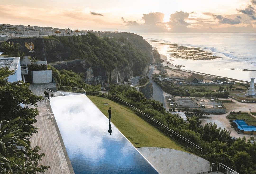 Latitude — the long glass-edged pool on the cliff at sunrise · Ungasan, Indonesia