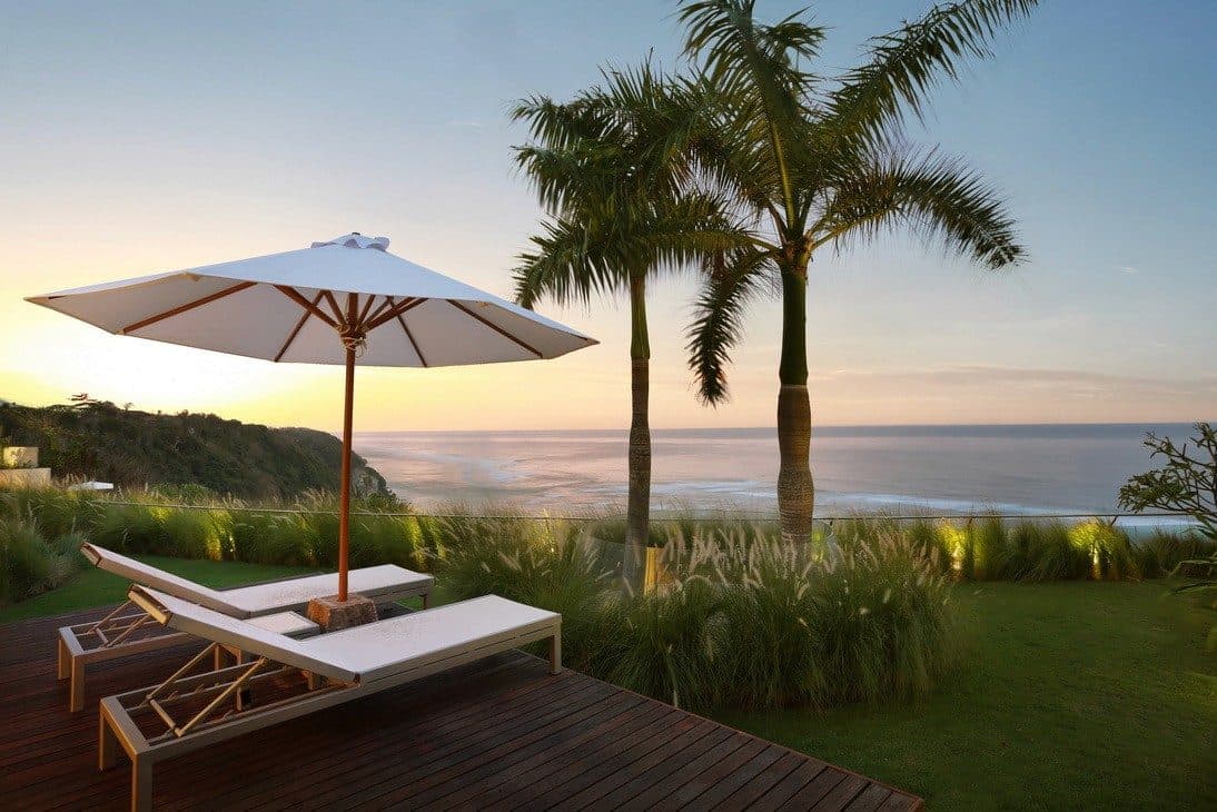 Latitude — loungers and a parasol on the deck at sunset · Ungasan, Indonesia