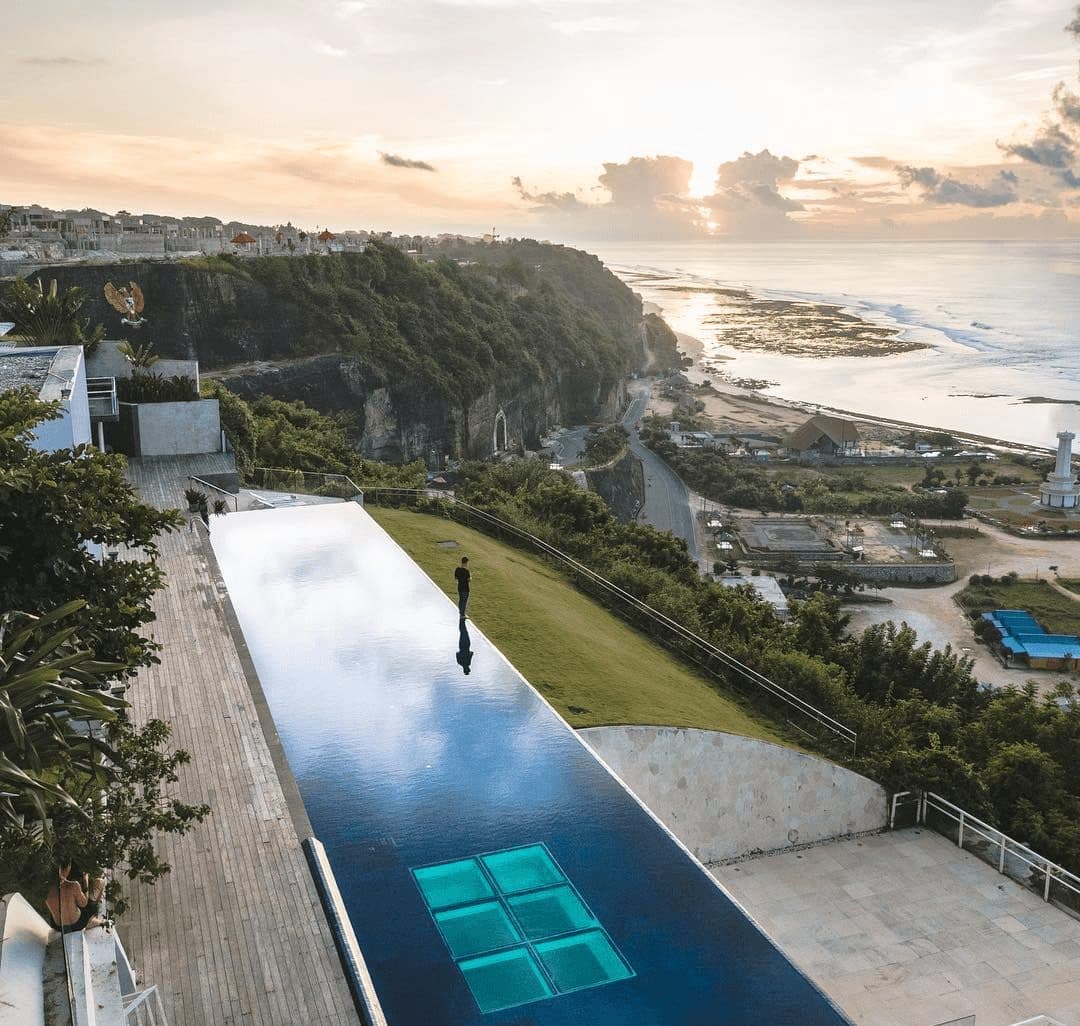 Latitude — the glass-bottomed pool reaching out over the cliff · Ungasan, Indonesia