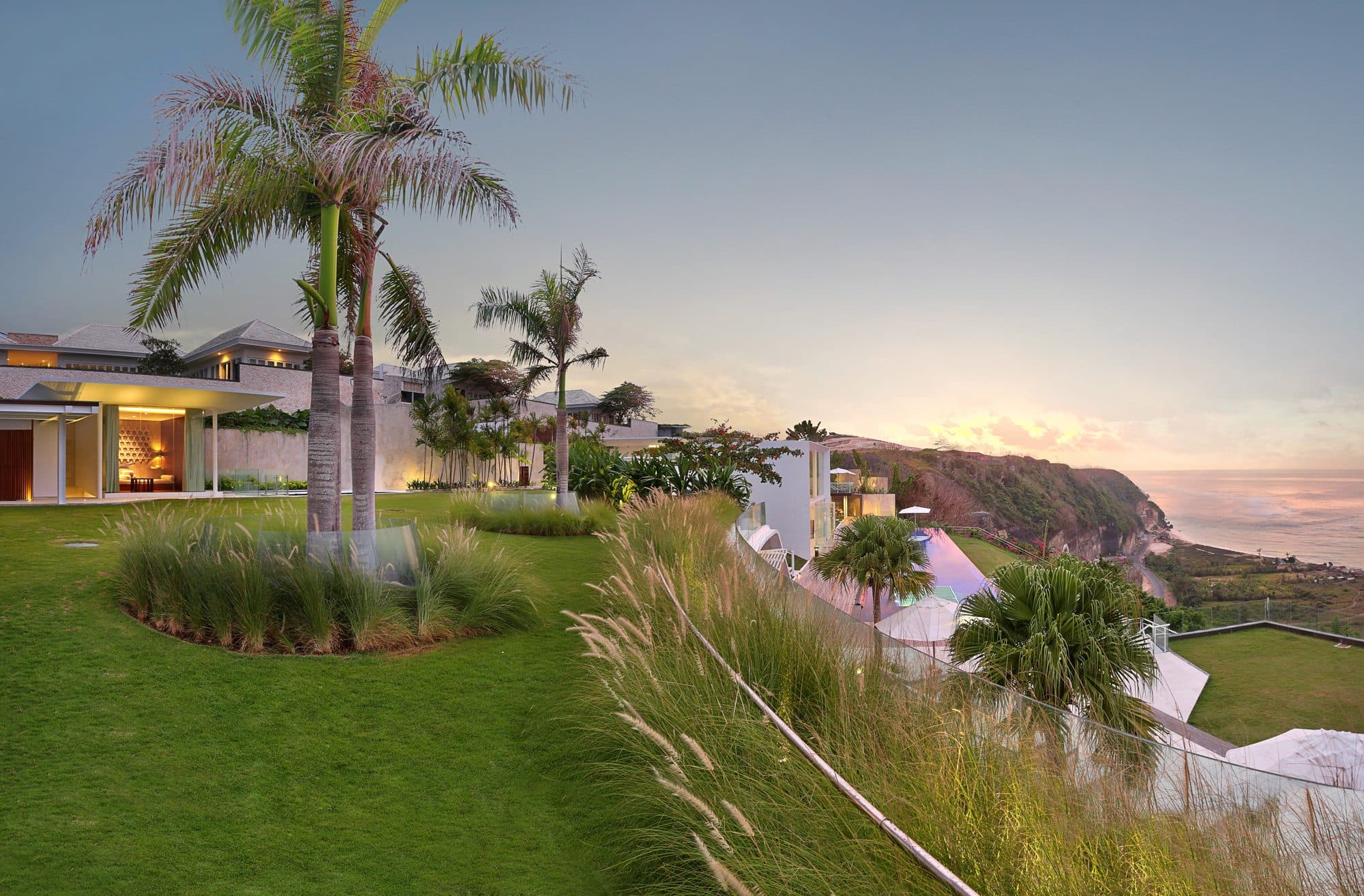 Latitude — the lawn and palms at dusk, the coast beyond · Ungasan, Indonesia