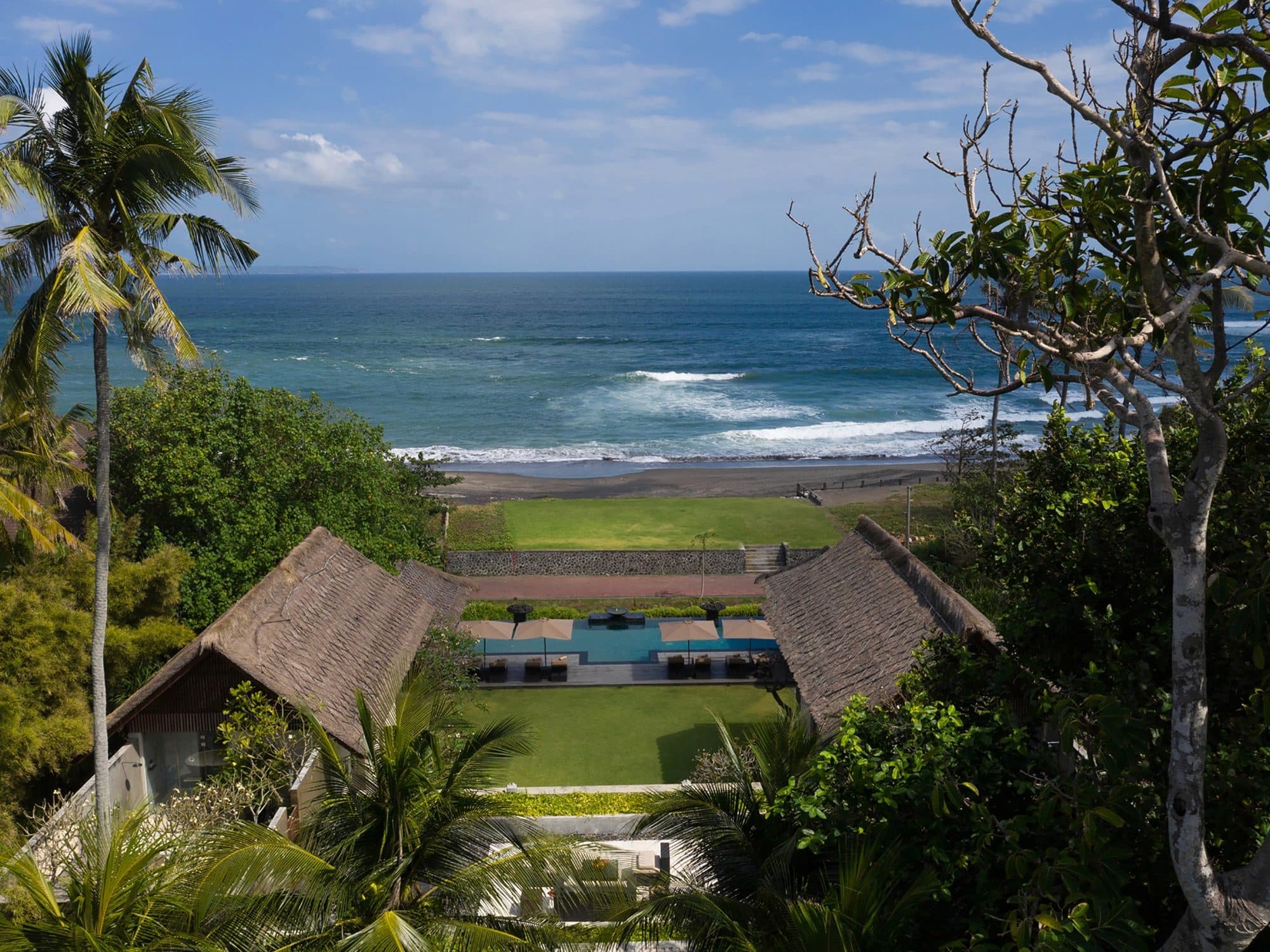 Seseh Beach Villas — the villas seen from above, the surf beyond · Seseh, Indonesia