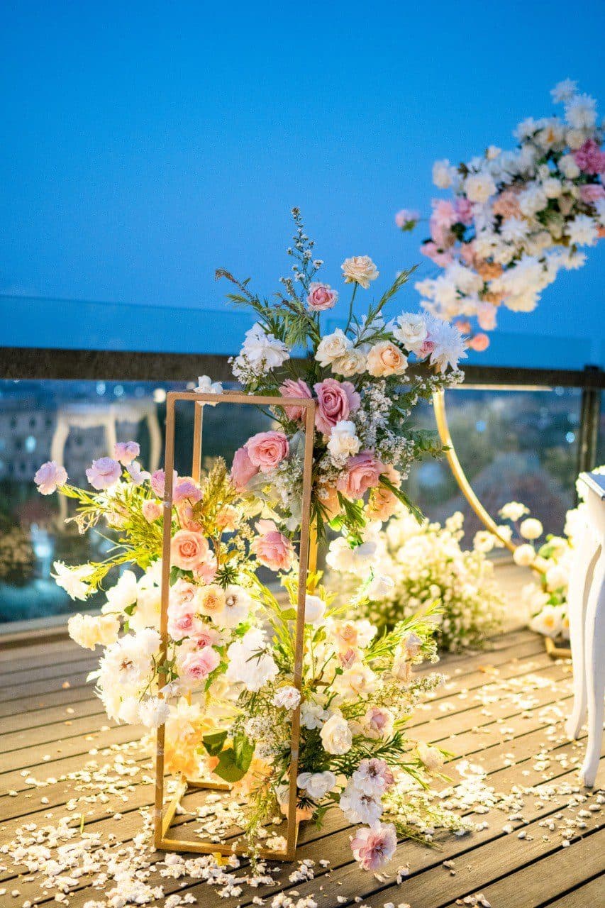 The Tulou Bali — floral stands on the deck at dusk · Jimbaran, Indonesia