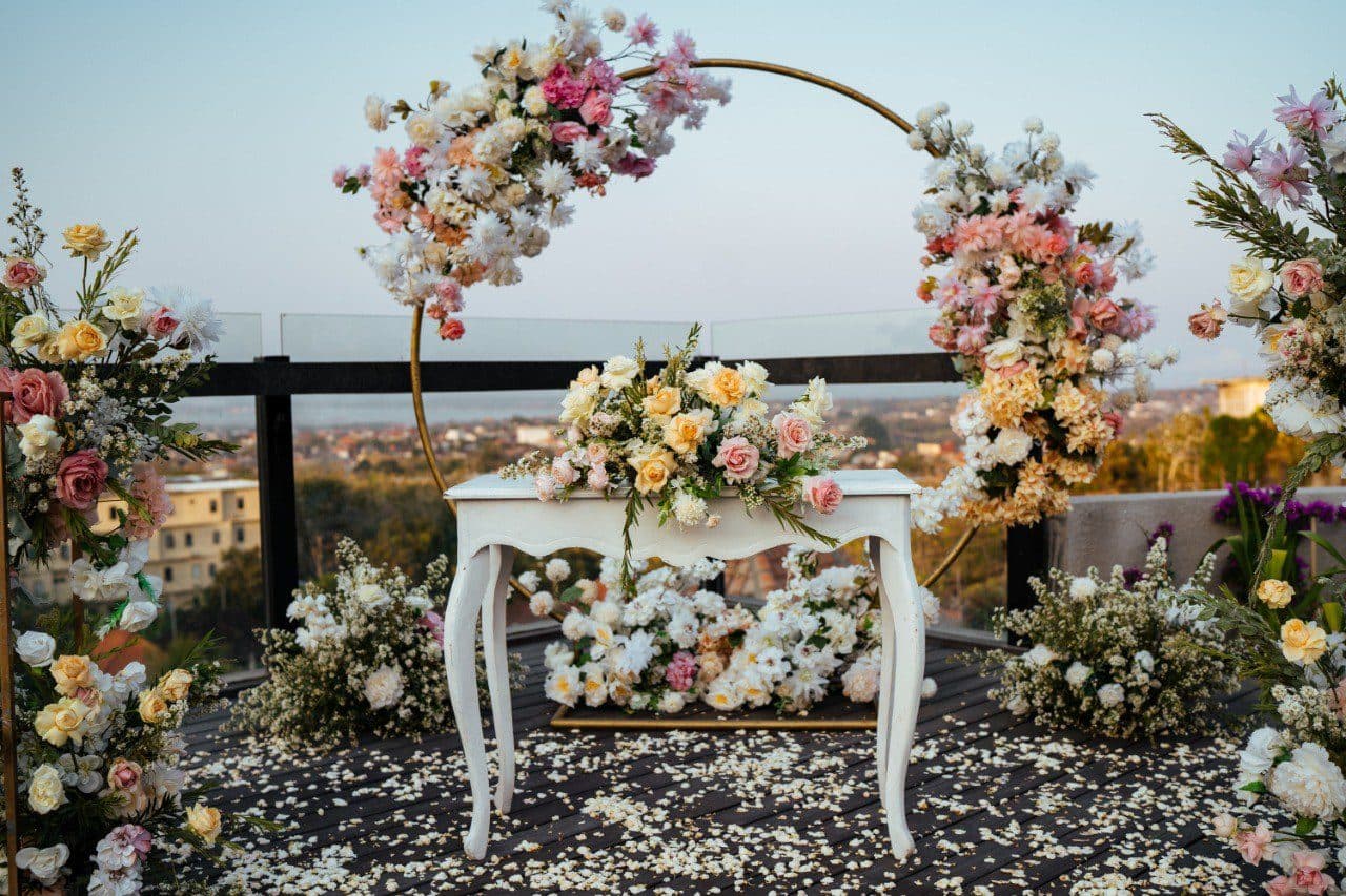 The Tulou Bali — a floral arch and signing table on the rooftop · Jimbaran, Indonesia