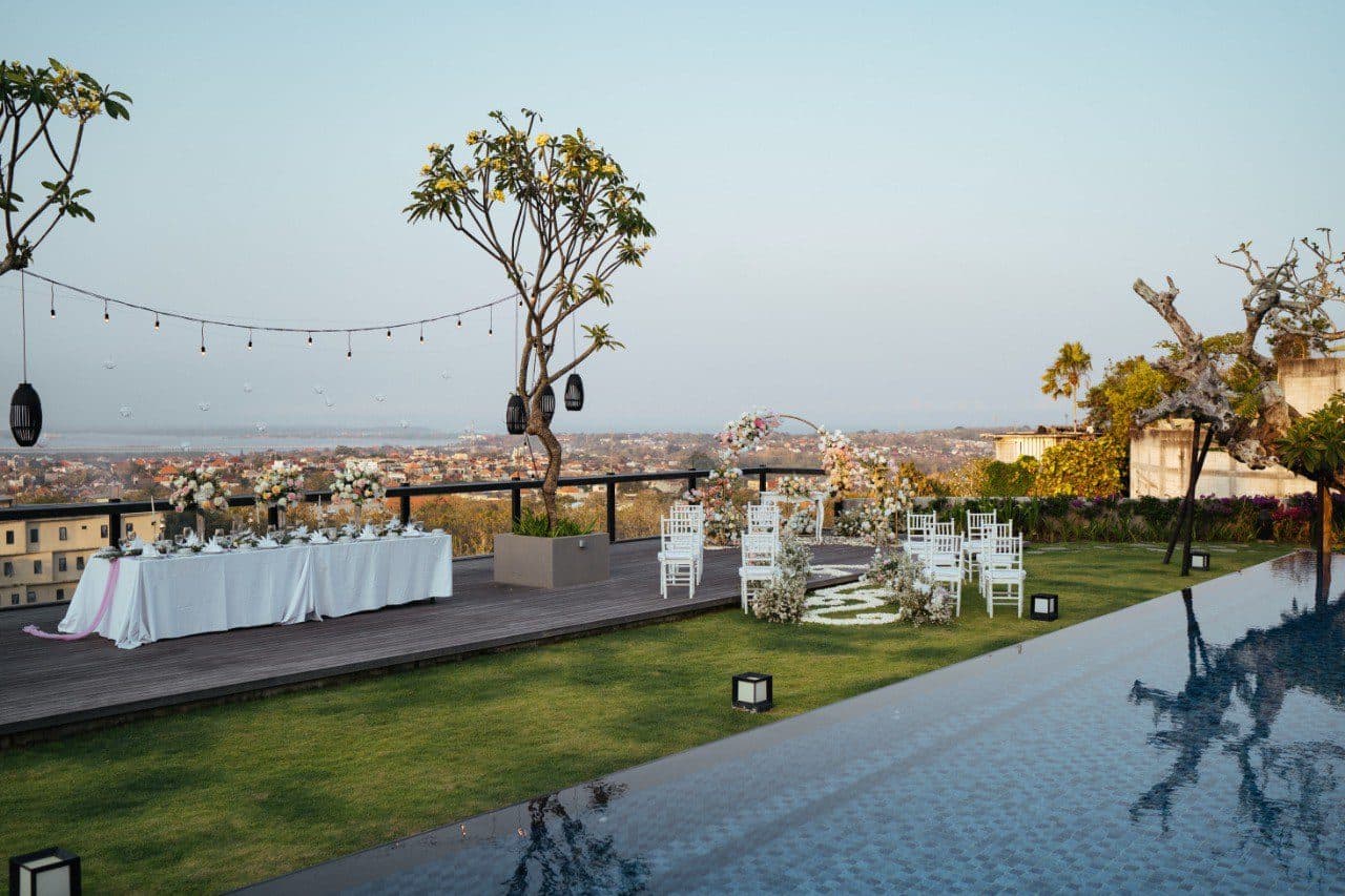 The Tulou Bali — the rooftop set for a reception beside the pool · Jimbaran, Indonesia