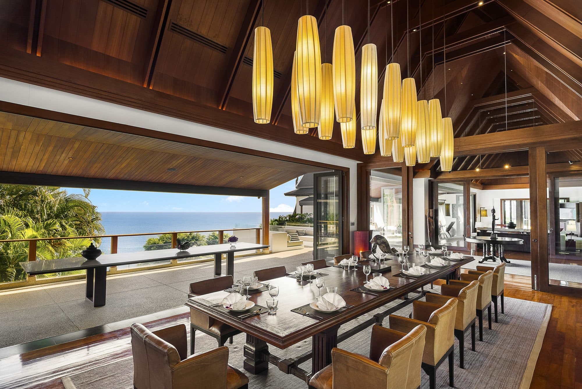 Villa Aye — the dining room with pendant lights, open to the sea view · Phuket, Thailand