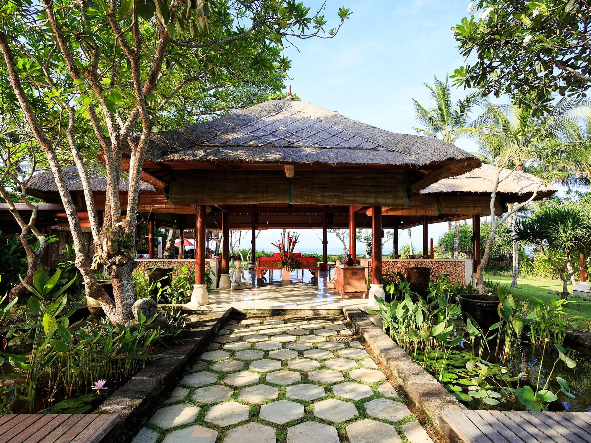 Villa Maridadi — the thatched pavilion at the end of a stepping-stone path · Cemagi, Indonesia