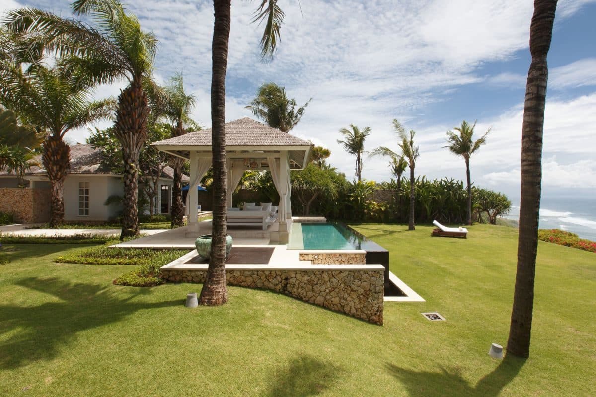 Villa Tamarama — the pavilion and pool seen across the lawn · Bali, Indonesia